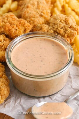 dish of Cane Sauce with chicken strips and fries