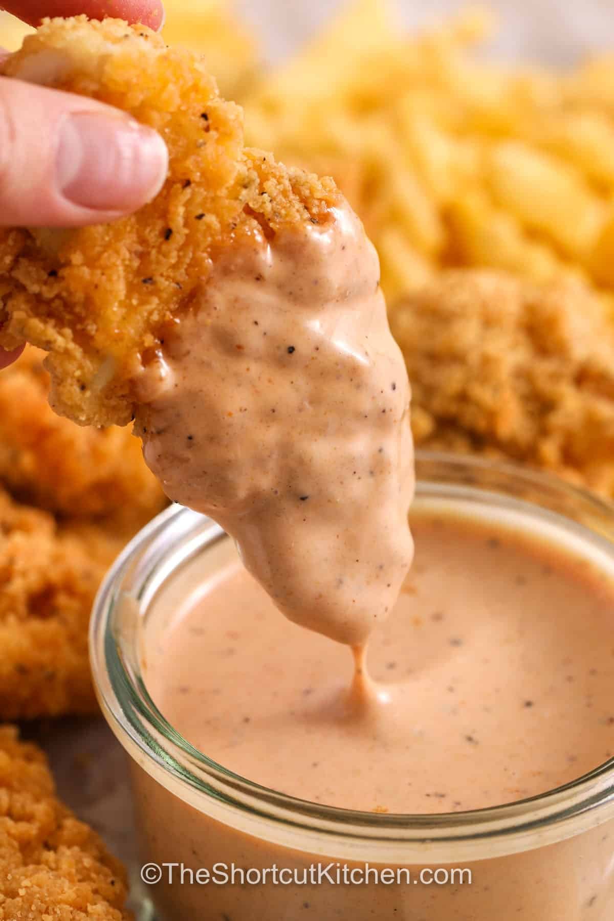 This easy canes sauce recipe is a quick copycat sauce you can stir together in minutes. Mayo and ketchup create the creamy base, Worcestershire adds savory depth, and fresh pepper gives that signature bite. Chill before serving so it tastes extra craveable. Use it as a dipping sauce for chicken tenders, fries, burgers, or wraps. #theshortcutkitchen dipping chicken in Cane Sauce