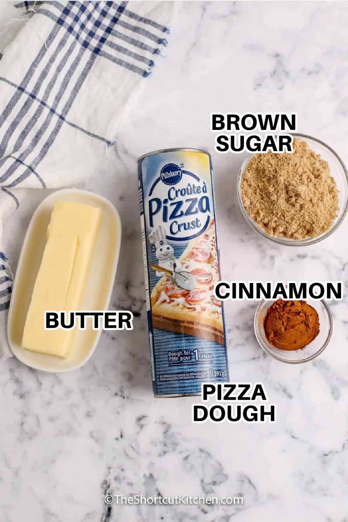 Make Pizza Dough Cinnamon Rolls when you want a no-yeast treat that’s ready in under an hour. Roll out refrigerated dough, coat with softened butter, sprinkle cinnamon and brown sugar, then roll and slice. Bake until lightly browned and finish with a quick powdered sugar glaze. Crescent roll cinnamon rolls work too, just press seams well, and bake until golden brown. #theshortcutkitchen brown sugar , cinnamon , pizza dough , butter with labels to make Pizza Dough Cinnamon Rolls