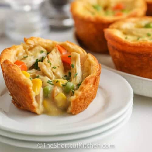 Mini Chicken Pot Pies with a one on a plate with a bite taken out
