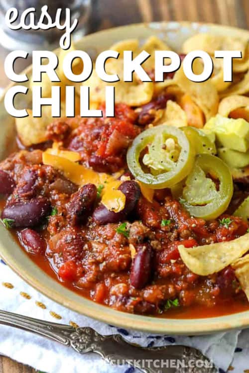 Make easy crockpot chili with pantry staples for big comfort food flavor. This crockpot chili recipe uses ground beef, onion, crushed tomatoes, Rotel-style diced tomatoes with chilies, and kidney beans for a thick, hearty bowl. Cook low and slow, then taste and season. Great for leftovers, meal prep, and a topping bar that makes everyone happy. #theshortcutkitchen Easy Crockpot Chili in a bowl with writing
