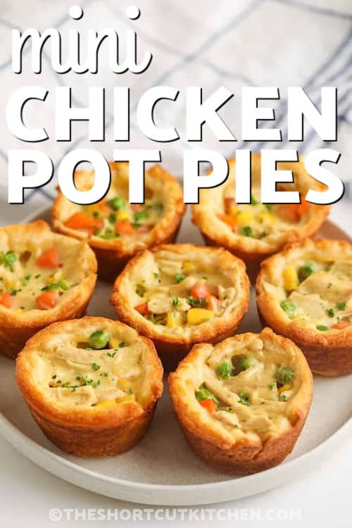 Muffin tin mini chicken pot pies are comfort food made easy. Use rotisserie chicken, frozen mixed veggies, and a quick creamy sauce with condensed cream of chicken soup. Press crescent rolls into the pan for a flaky crust, fill, and bake until golden brown. These crescent roll chicken pot pies are easy to portion, great for kids, and ideal for make-ahead dinners. #theshortcutkitchen plate of Mini Chicken Pot Pies with writing