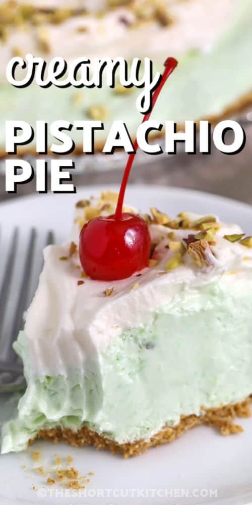 This Pistachio pie is a dreamy no bake pistachio pie that comes together in minutes. Beat cream cheese, mix in instant pistachio pudding, add cold milk, then fold in Cool Whip for a fluffy pistachio pudding pie filling. Spoon into a graham cracker crust and chill until set. Top with crushed pistachios for crunch or cherries for a retro look. #theshortcutkitchen creamy Pistachio Pie slice on a plate with writing
