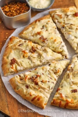 cheesy Chicken Alfredo Pizza cut into slices