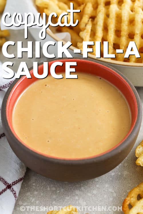 Chick-Fil-A sauce recipe lovers will enjoy this easy homemade version that brings that sweet, smoky, and tangy flavor right to your kitchen. Made with simple pantry ingredients like mayo, BBQ sauce, and honey, this copycat Chick-Fil-A sauce recipe is perfect for dipping chicken nuggets, fries, or spreading on sandwiches. It blends smoothly and is creamy every time for a bold flavor boost to any meal. #theshortcutkitchen small bowl of Chick-Fil-A sauce recipe with waffle fries in background
