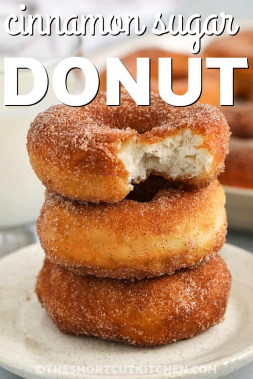 Make cinnamon sugar donuts at home without yeast using this easy donut recipe. Canned biscuits fry up fluffy, then get brushed with melted butter so cinnamon sugar coats every bite. Use the cut-out centers for donut holes and serve warm. Add a simple vanilla glaze or chocolate glaze for variety, plus air fryer donuts directions. #theshortcutkitchen staked donuts with writing