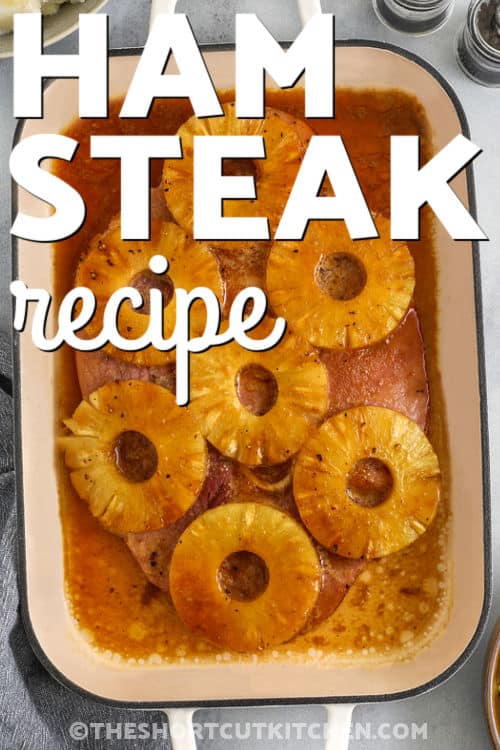 This ham steak recipe is baked with pineapple and creates a delicious dinner that everyone will enjoy. The ham steak is topped with pineapple rings and covered in a sweet brown sugar glaze that caramelizes in the oven. Dijon mustard and soy sauce add a savory depth that balances the sweetness. This recipe works well for a weeknight dinner or a small holiday meal. Serve it with mashed potatoes, rice, or roasted vegetables for a complete meal. #theshortcutkitchen Ham Steak with pineapple rings in a dish with a title