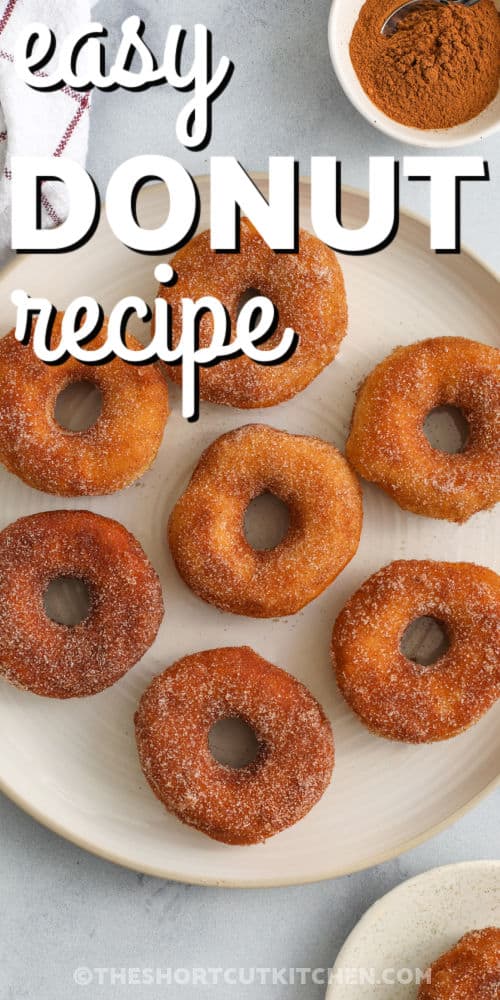 7 donuts on a plate with writing