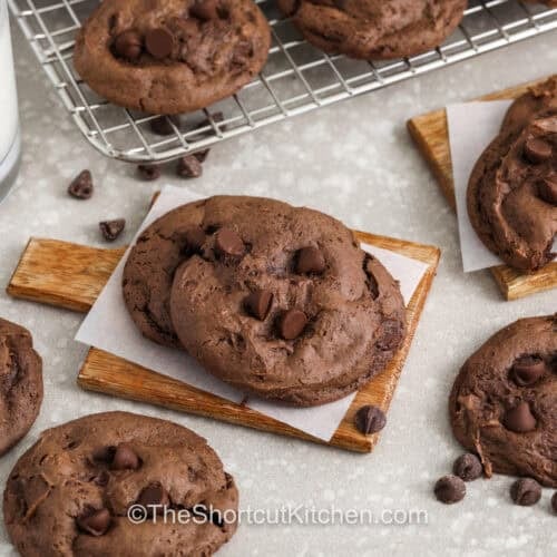 Chocolate Cake Mix Cookies with a bite taken out of one and a glass of milk