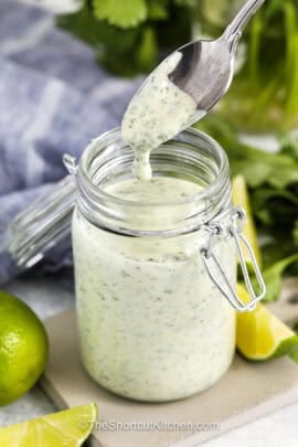 taking a spoonful of Cilantro Garlic Sauce out of the jar