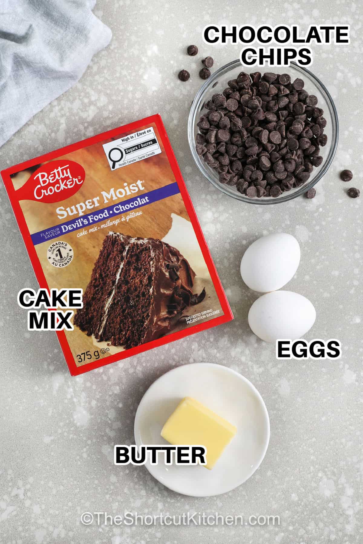Chocolate cake cookie mix makes this recipe incredibly easy while still delivering cookies that taste like they came straight from a bakery. The texture is soft and gooey in the center with slightly crisp edges, and the chocolate chips add extra richness throughout. Everything mixes together in one bowl, making cleanup just as simple as the baking process itself for a quick homemade treat. #theshortcutkitchen chocolate chips , cake mix , eggs , butter with labels to make Chocolate Cake Mix Cookies