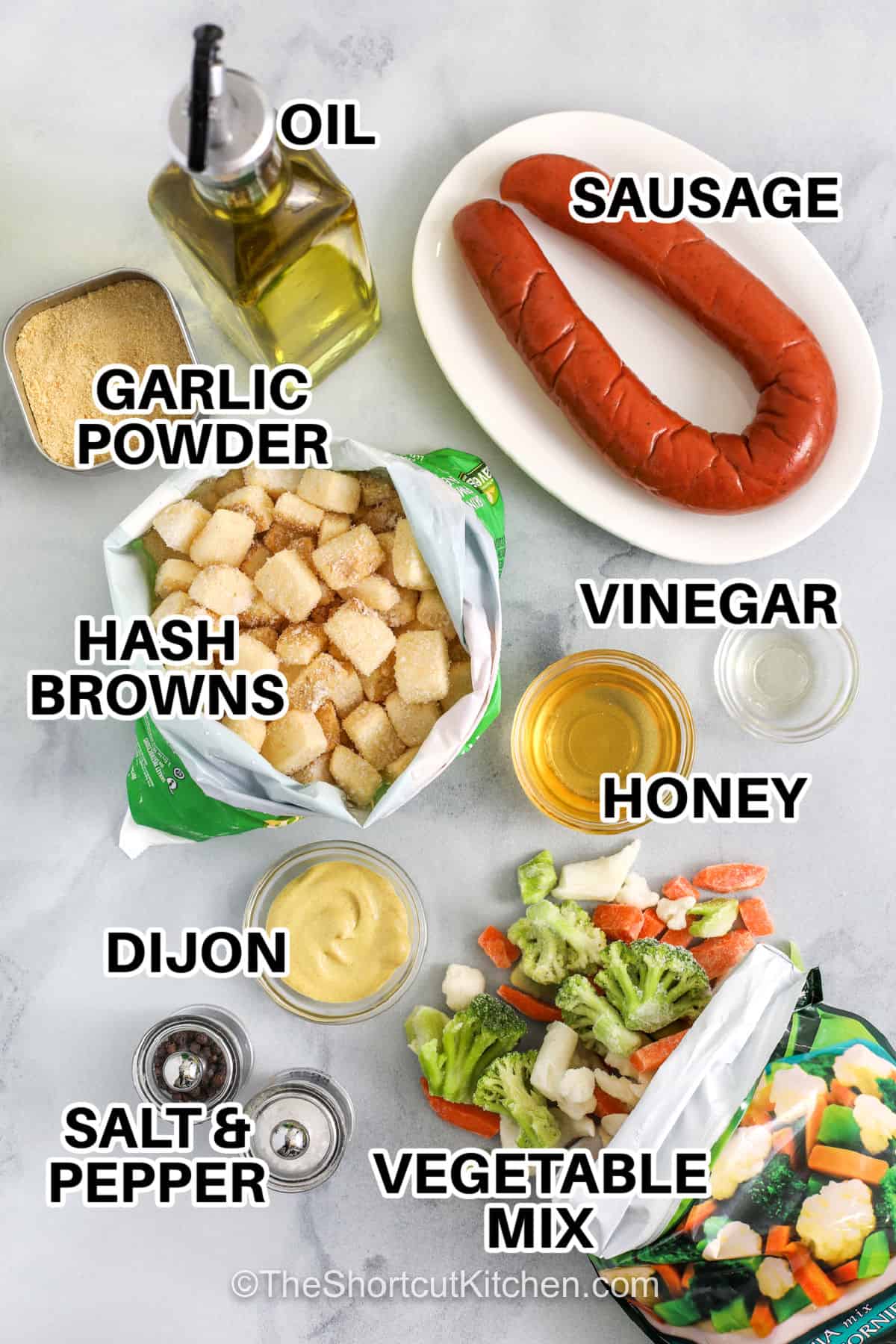 Sheet pan sausage and veggies are packed with roasted flavor and easy ingredients. Frozen vegetables and diced potatoes bake until golden, while smoky sausage adds hearty flavor to every bite. A homemade honey Dijon sauce brings everything together with a sweet and tangy finish. This easy sheet pan dinner keeps cleanup simple and makes feeding the family stress-free. Make this easy sausage and veggie recipe for dinner soon. #theshortcutkitchen garlic powder , oil , sausage , hash browns , vinegar , honey , dijon , vegetable mix , salt and pepper with labels to make Sheet Pan Sausage and Veggies