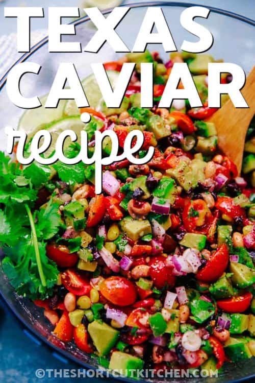 If you love fresh, scoopable dips, this Texas caviar recipe is a must-make. Loaded with black beans, black eyed peas, corn, tomatoes, red pepper, jalapenos, and cilantro, this cowboy caviar is tossed in a zesty dressing for big flavor in every bite. Serve it cold as a party dip, picnic side, or easy snack with chips. #theshortcutkitchen bowl of Texas Caviar Recipe with wooden spoon and a title