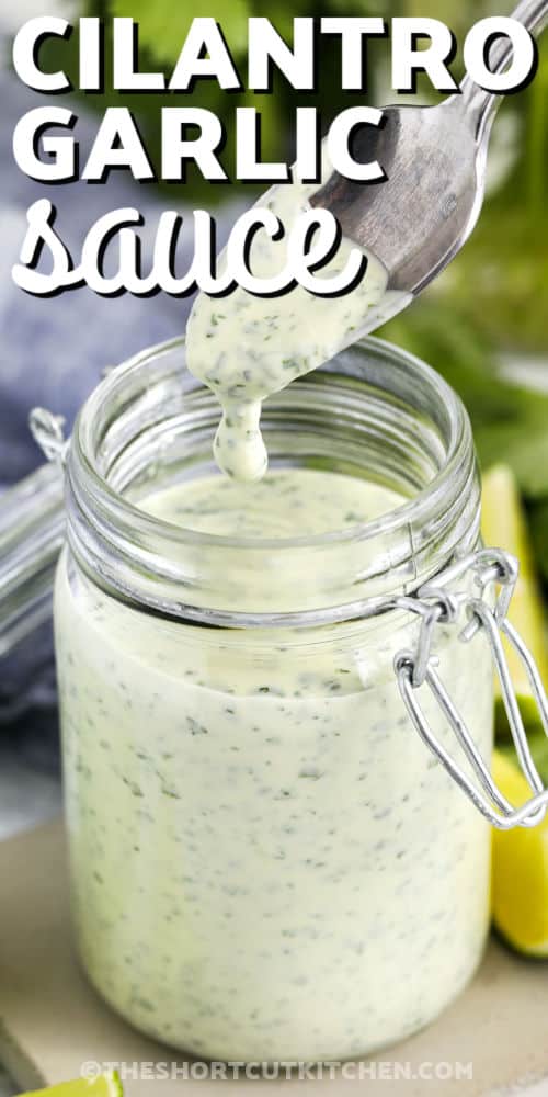 taking a spoonful of Cilantro Garlic Sauce out of the jar with a title