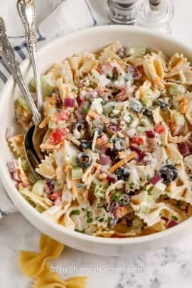 bowl of Bow Tie Pasta Salad with a fork and spoon