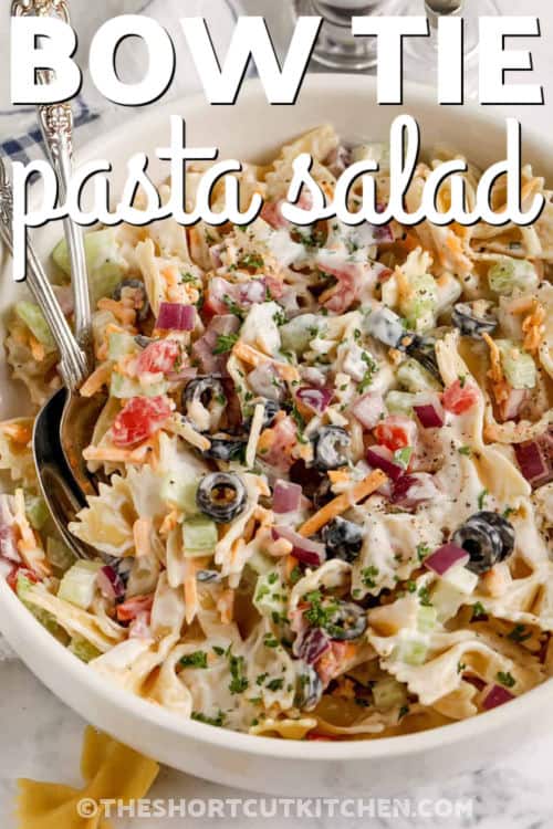 Make this easy bow tie pasta salad when you need a quick side dish that feels fresh, creamy, and filling. Bow tie pasta is tossed with ranch dressing, shredded cheddar, diced tomatoes, celery, onion, and olives. It is the perfect chilled pasta salad that pairs with burgers, chicken, sandwiches, or pulled pork sliders. #theshortcutkitchen creamy Bow Tie Pasta Salad with a title
