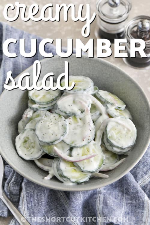 This creamy cucumber salad recipe is the perfect side dish for warm-weather meals and backyard cookouts. Crisp cucumbers and red onion are tossed in a creamy dill dressing with just the right tangy flavor. It pairs well with burgers, grilled chicken, sandwiches, and picnic favorites. Every bite is cool, fresh, and packed with simple homemade flavor. Keep this easy cucumber salad chilled and ready for dinner all summer long. Save this family favorite recipe today. #theshortcutkitchen plated Creamy Cucumber Salad Recipe with a title