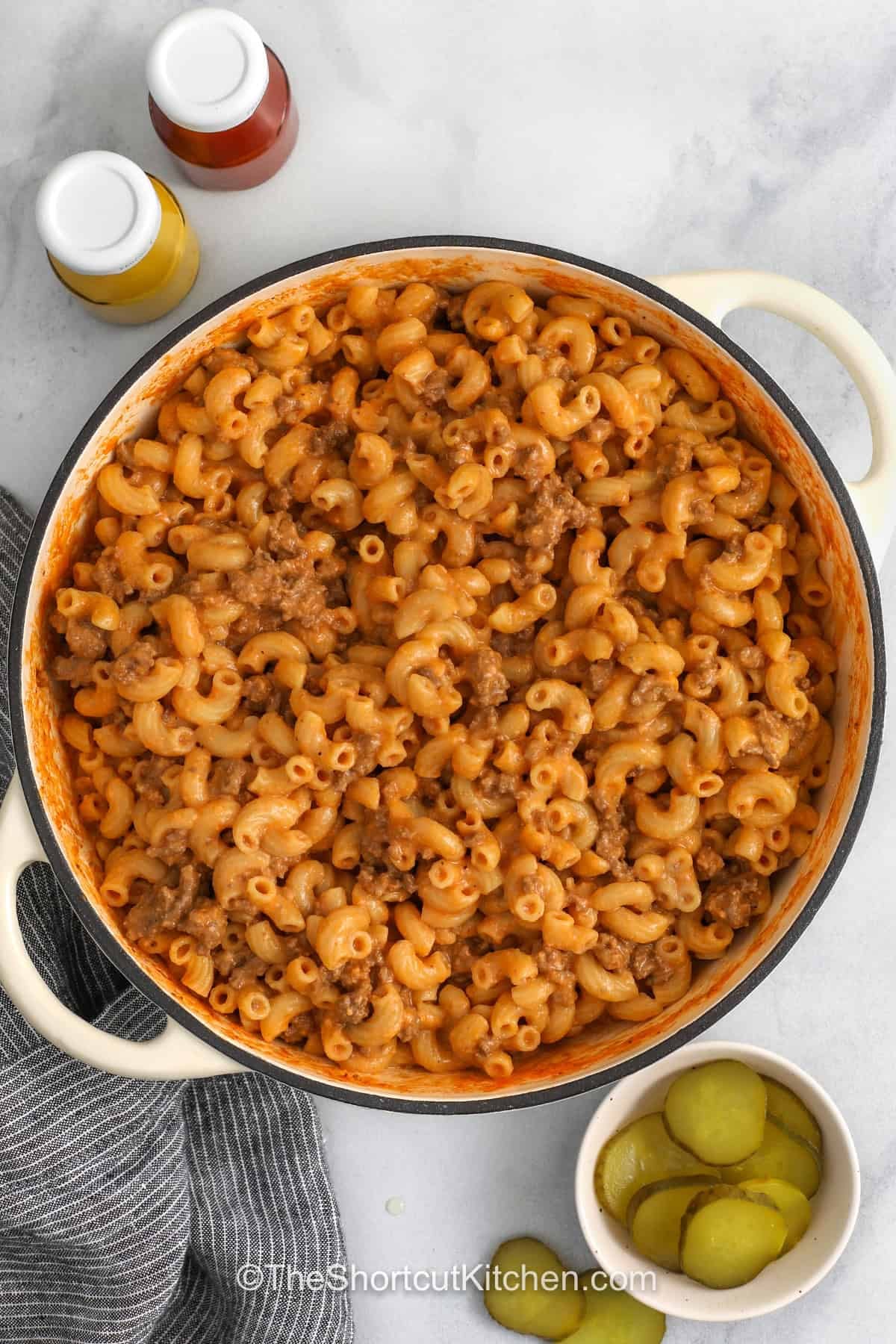 Homemade Cheeseburger Pasta is an easy skillet dinner made with ground beef and macaroni in a creamy cheddar sauce. Ketchup and mustard add that classic burger taste, while cream cheese makes the sauce smooth and rich. This cheeseburger macaroni is simple, cozy, and perfect for weeknight cooking. Up the burger flavor, and serve with an assortment of classic toppings like pickles, diced tomatoes, shredded lettuce, or crispy bacon. Save this weeknight winner today! #theshortcutkitchen pot of One Pot CheeseBurger Pasta