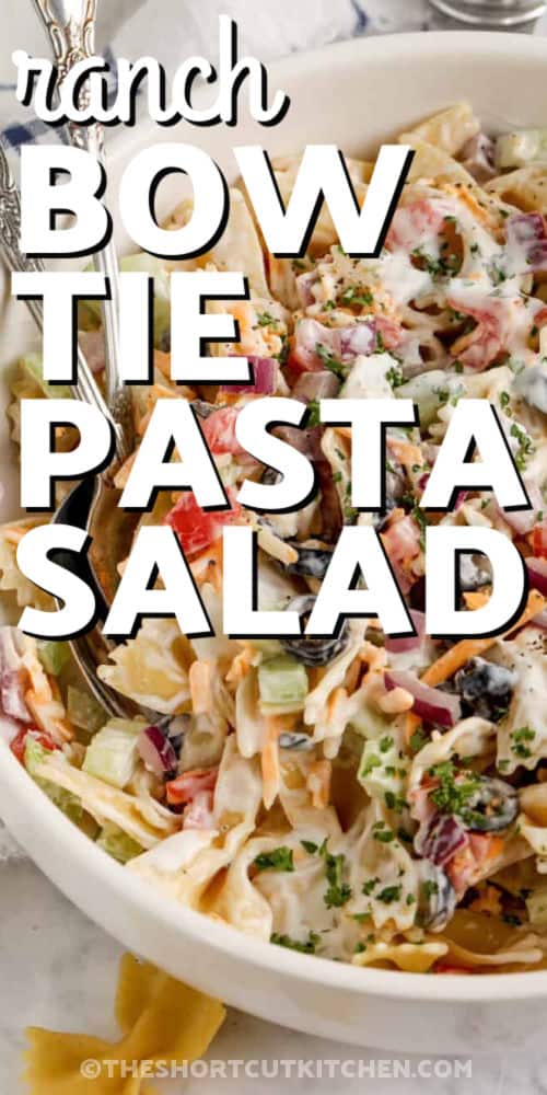 Creamy bow tie pasta salad is a simple ranch pasta salad with cheddar cheese and crisp vegetables. The pasta is cooked al dente, cooled completely, and tossed with ranch for a make-ahead side dish that works for potlucks, cookouts, family dinners, and summer lunches. Add bacon or chicken to make it heartier. #theshortcutkitchen ranch Bow Tie Pasta Salad in a bowl with writing