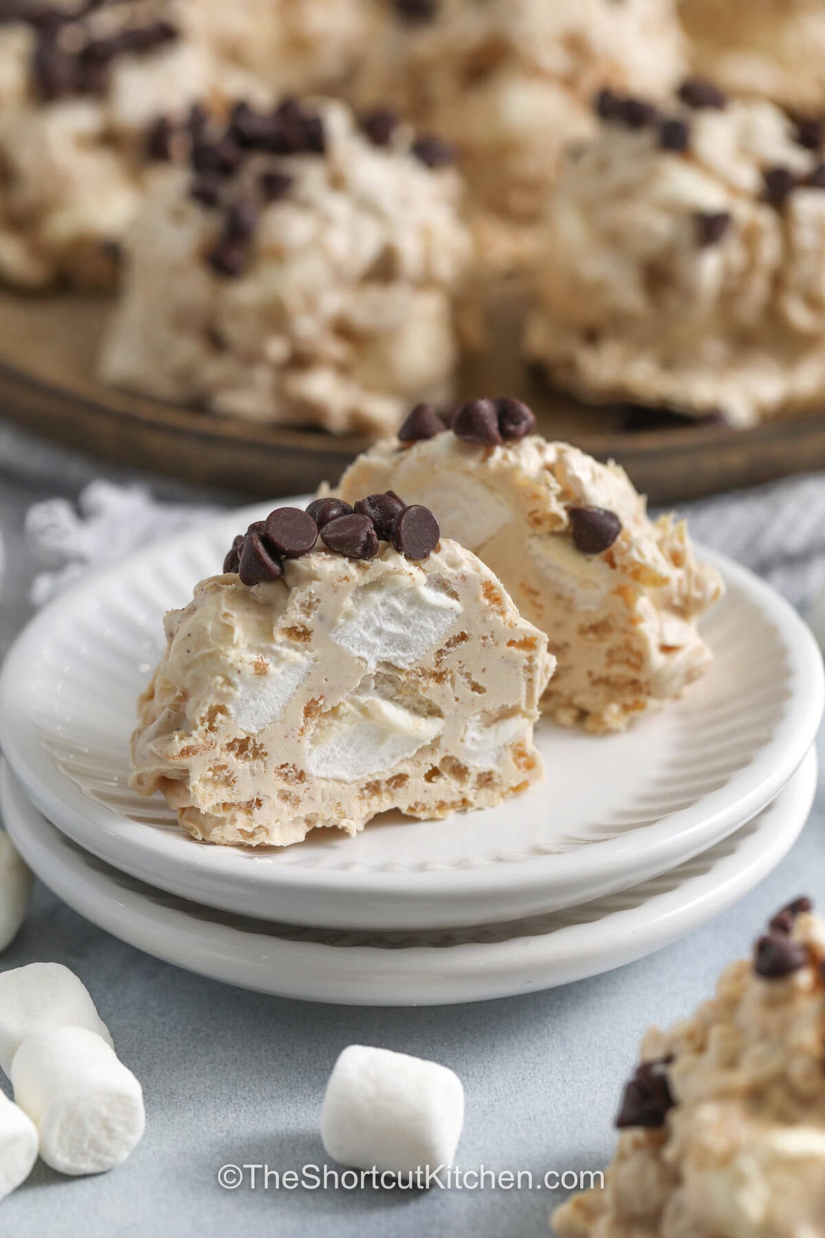 Avalanche cookies are a sweet and crunchy no-bake dessert packed with creamy peanut butter, white chocolate, marshmallows, and crisp rice cereal. Every bite is soft, chewy, and full of rich flavor with just the right crunch. These easy cookies are perfect for holiday trays, bake sales, or quick family treats. They come together with simple pantry ingredients and are always a hit. Make a batch today and share the sweetness. #theshortcutkitchen plated Avalanche Cookies