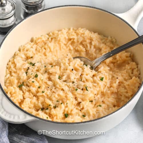 Cheesy Rice in a pot with a spoon