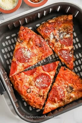 pepperoni pizza in an air fryer to show How to Reheat Pizza in the Air Fryer