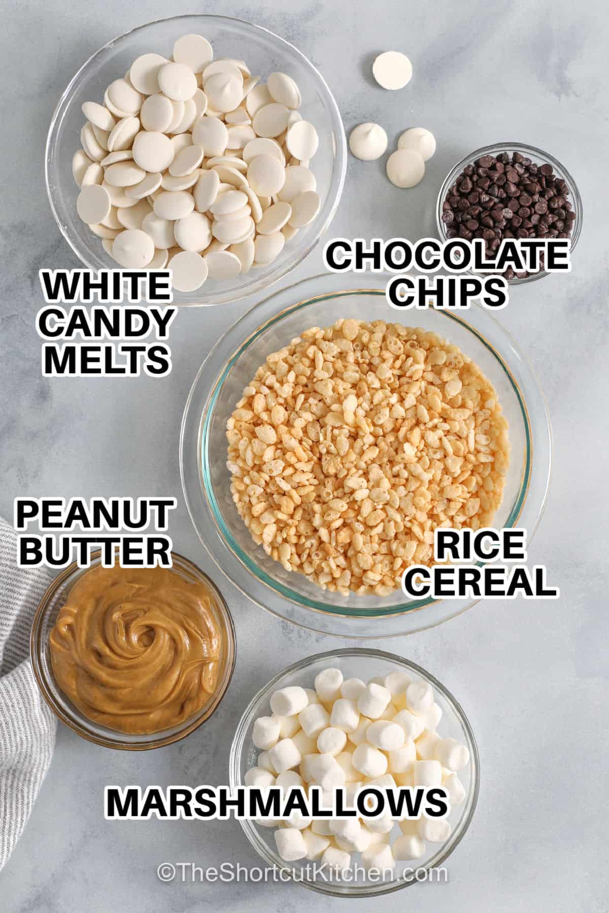 Easy avalanche cookies are always a favorite when you need a fun, no-bake dessert to share. Rich peanut butter, white chocolate, marshmallows, and crisp rice cereal create cookies with plenty of texture and flavor. They are perfect for parties, family gatherings, or satisfying a sweet craving with minimal effort. Keep this recipe handy and make a batch soon. #theshortcutkitchen white candy melts , chocolate chips , rice cereal , peanut butter , marshmallows with labels to make Avalanche Cookies