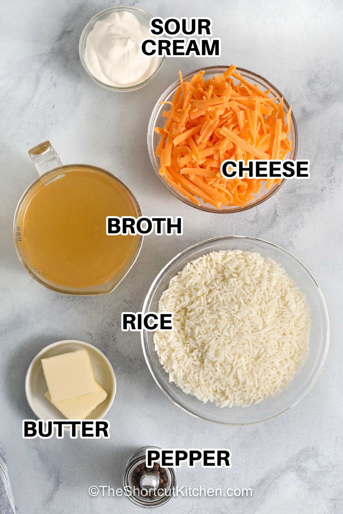 Homemade cheesy rice brings rich flavor and cozy comfort to the dinner table. This creamy side dish is easy to make and goes with everything from grilled chicken to juicy pork chops. It is a simple recipe made with everyday ingredients that the whole family will enjoy. Perfect for weeknight dinners or holiday meals, it is always a crowd pleaser. Keep this recipe handy whenever you need an easy side dish. Give it a try today. #theshortcutkitchen sour cream , cheese , broth , rice , pepper , and butter with labels to make Cheesy Rice