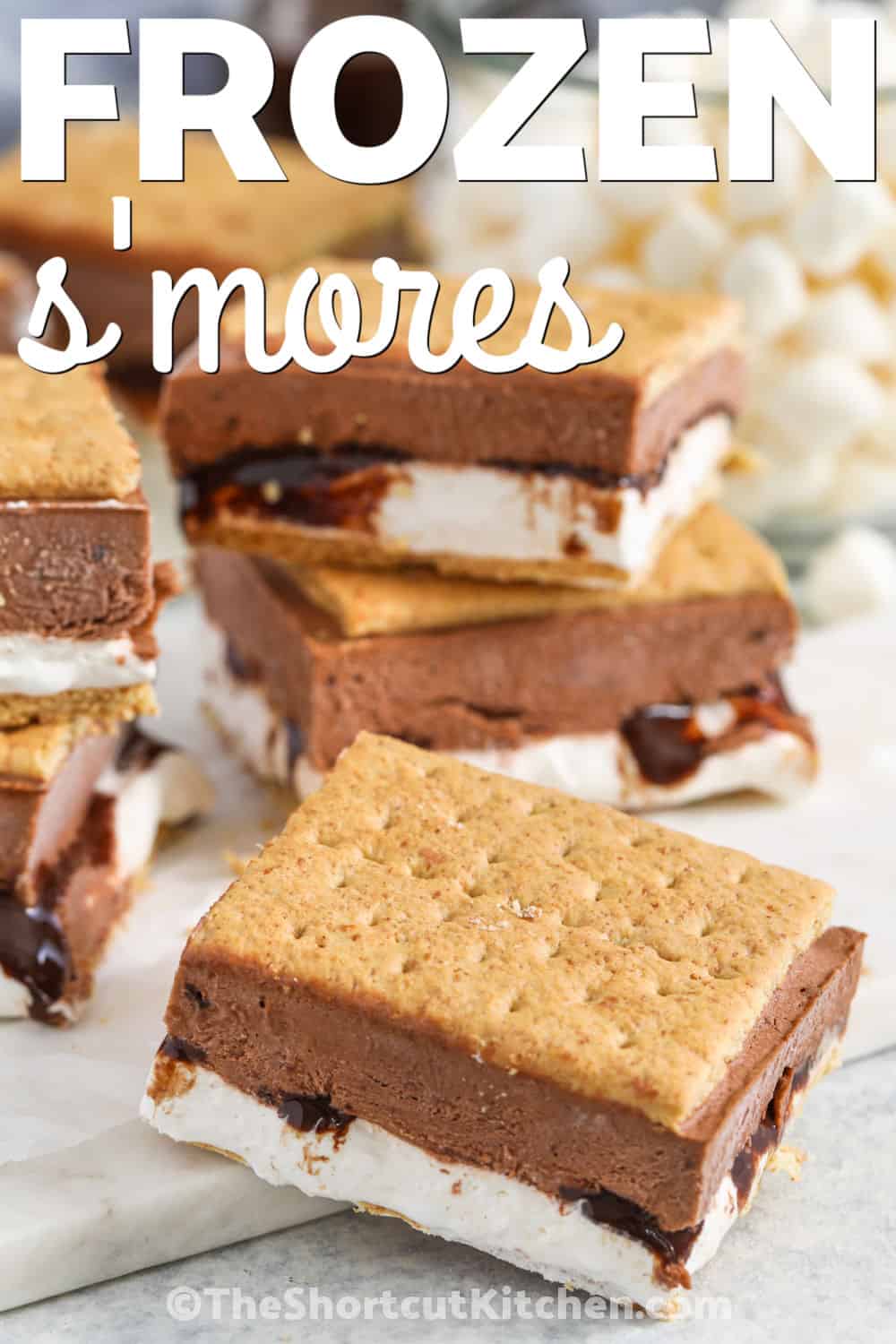 Frozen S’mores are the perfect make-ahead freezer dessert with graham crackers, chocolate pudding, and marshmallow fluff in every bite. This no-bake frozen s’mores recipe takes just minutes to layer before freezing and makes a sweet handheld treat for summer gatherings, parties, and warm nights. Pin this easy freezer dessert for later. #theshortcutkitchen cool Frozen S'mores with a title