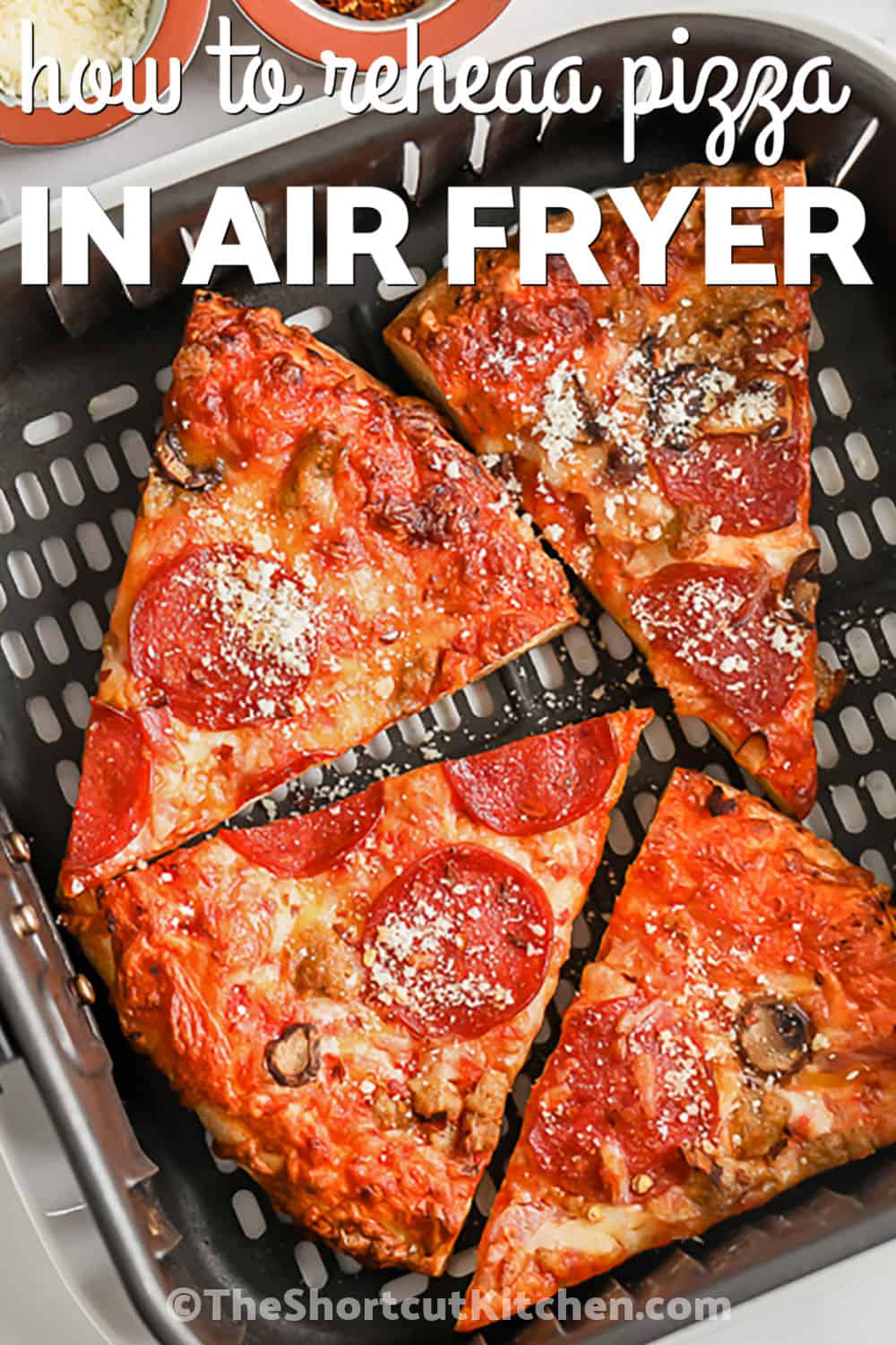 Learn how to reheat pizza in the air fryer so leftover pizza tastes fresh again. Cold cheese pizza, pepperoni pizza, or veggie pizza heats quickly at 350°F with a crisp bottom and melty top. This simple cooking method is faster than the oven and better than the microwave. It is perfect for one or two slices when you want a hot, crispy snack without extra dishes. Pin this air fryer pizza trick for later. #theshortcutkitchen cooked pizza in an air fryer with writing to show How to Reheat Pizza in the Air Fryer