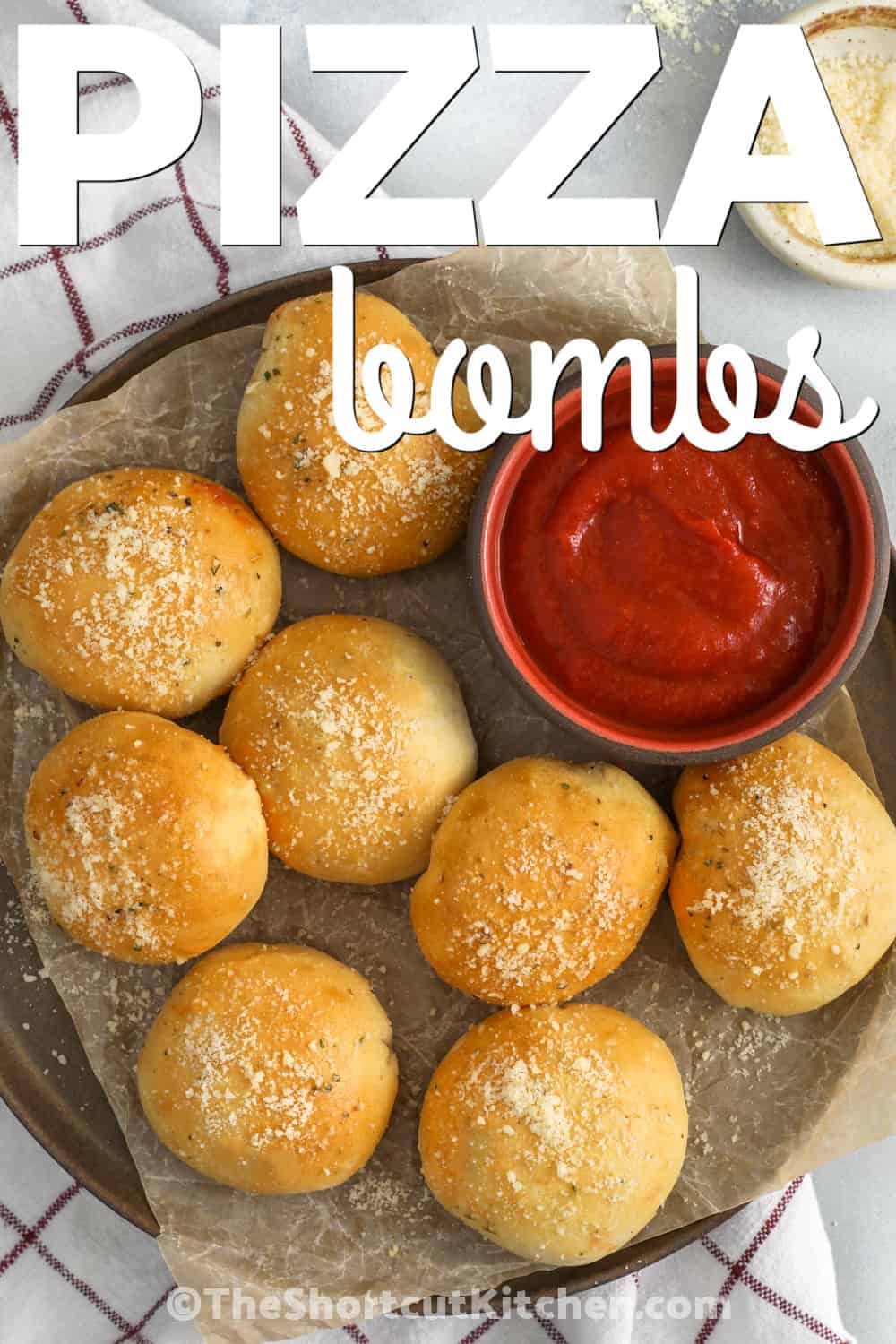 Pizza bombs are an easy oven-baked appetizer with biscuit dough, pizza sauce, pepperoni, mozzarella cheese, and parmesan. They are soft inside, golden outside, and perfect for dipping into warm pizza sauce. This shortcut recipe is simple enough for busy nights but fun enough for game day, sleepovers, and casual family gatherings. Pin this recipe for an easy appetizer idea. #theshortcutkitchen pizza bombs on a plate with writing
