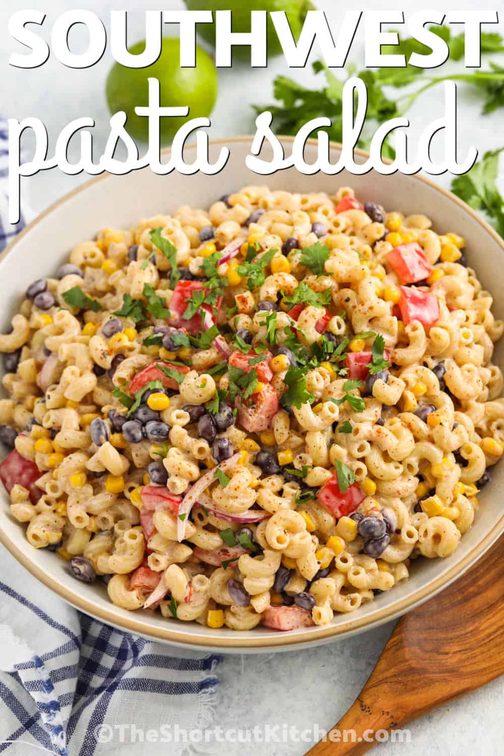 This cold southwest pasta salad recipe is creamy, tangy, and packed with easy pantry ingredients like macaroni, black beans, canned Southwest corn, and taco seasoning. The ranch lime dressing coats every bite for a flavorful side that is perfect for potlucks, picnics, and weeknight dinners. Use red pepper or cherry tomatoes for color and crunch. Pin it now for an easy make-ahead recipe. #theshortcutkitchen plated Southwest Pasta Salad with lime and a title