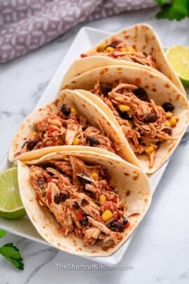 plate of Crockpot Shredded Chicken Tacos with lime