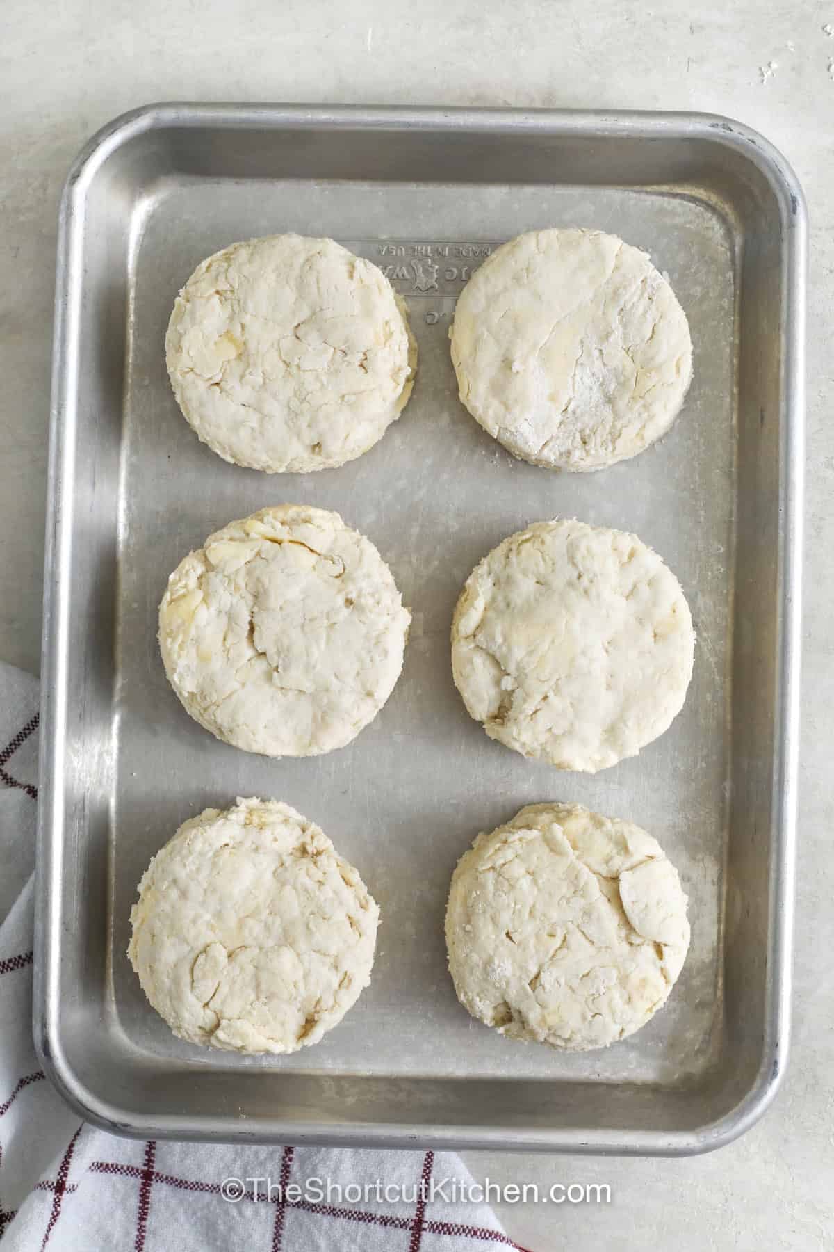 7up biscuits are a simple way to add warm, homemade goodness to any meal. Made with Bisquick, sour cream, butter, and lemon-lime soda, these easy biscuits bake up light and fluffy. They are wonderful with butter and jam or served beside soup, chili, or sausage gravy. Keep this easy biscuit recipe handy whenever you want a comforting side without much fuss. Give these 7up biscuits a try today and enjoy a homemade favorite. #theshortcutkitchen 7up Biscuits on a sheet pan before cooking