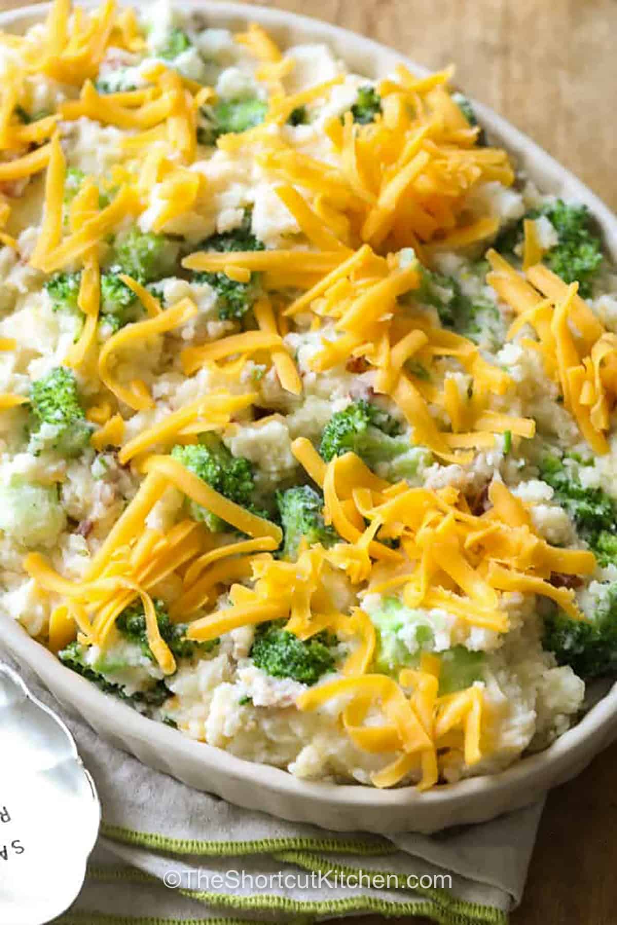 This cheesy broccoli potato casserole tastes like a loaded baked potato in an easy, scoopable side dish. Mashed russet potatoes are combined with bite-sized broccoli, crisp bacon, sour cream, cream cheese, Parmesan, and plenty of cheddar. The oven-baked topping becomes melted and bubbly while the center stays creamy. Save this bacon broccoli potato casserole for your next comfort-food meal. #theshortcutkitchen Broccoli Potato Casserole before baking