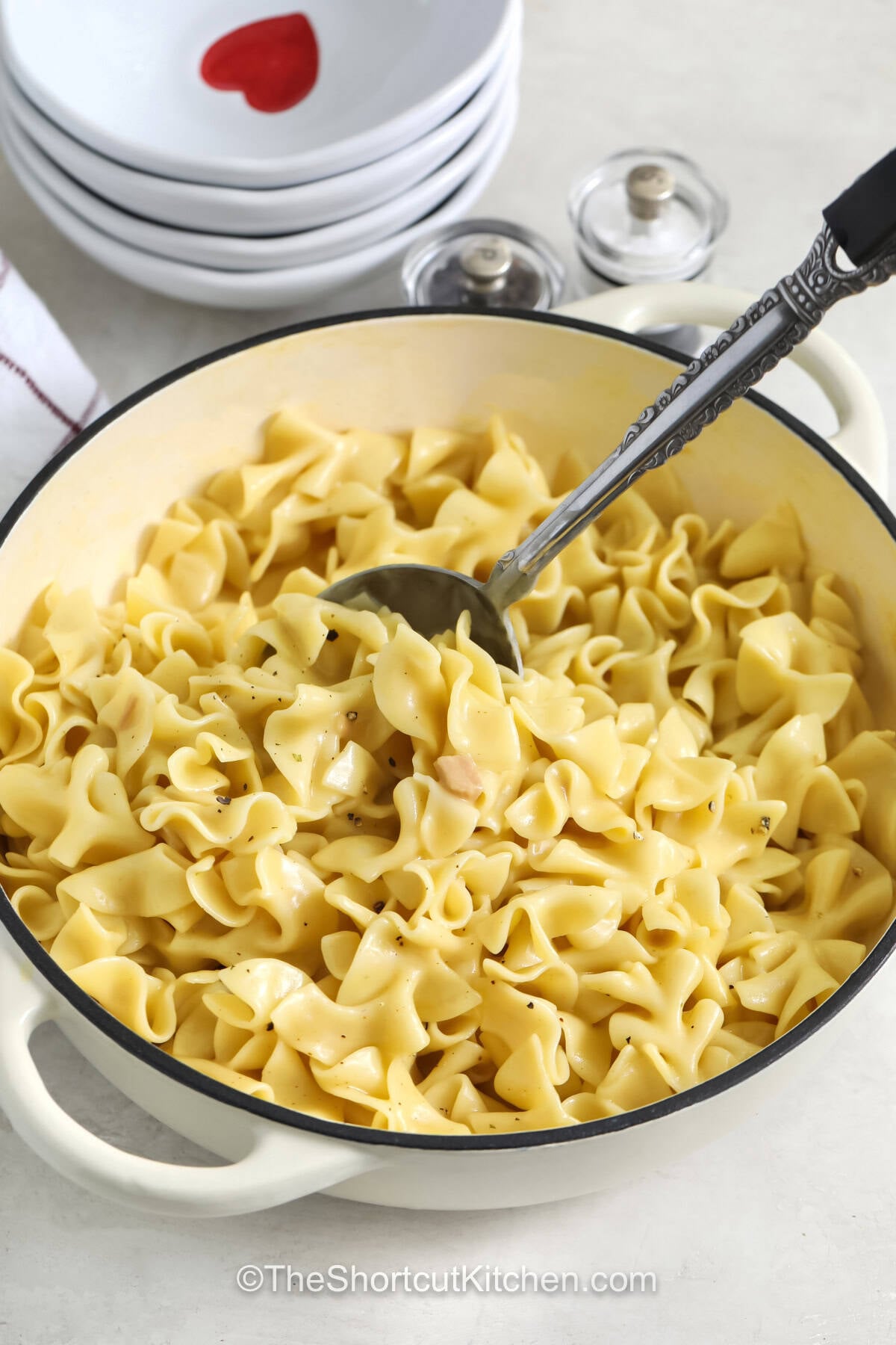 Delicious cafeteria noodles are the easy comfort food side dish your family will request again and again. Tender noodles soak up a creamy chicken broth mixture to create a savory dish that goes perfectly with classic dinners. This simple recipe is great for holidays, weeknight meals, or whenever you need a cozy side that everyone can enjoy. Make these cafeteria noodles and bring extra comfort to your table. #theshortcutkitchen Cafeteria Noodles in a pot