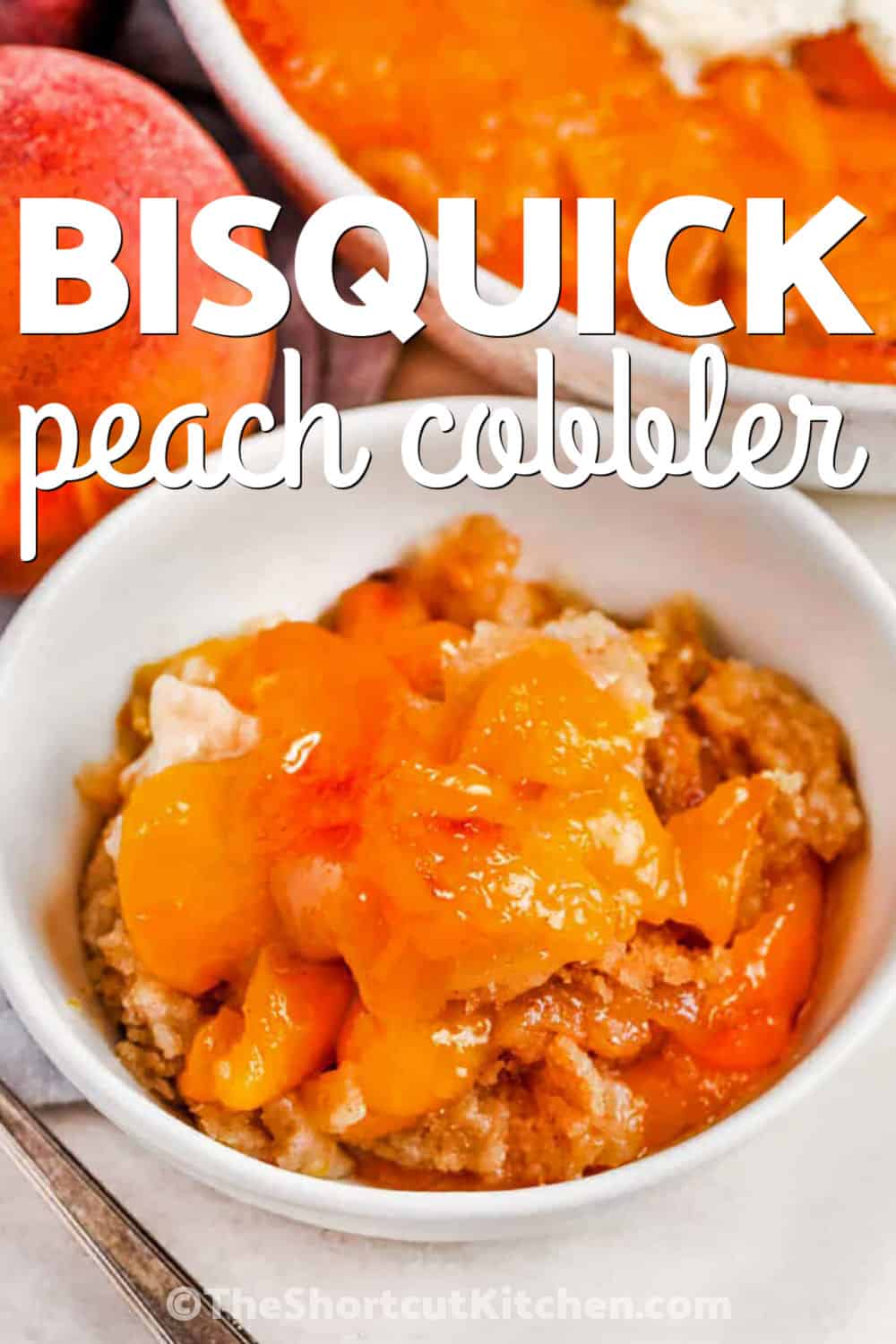 This Bisquick peach cobbler is an easy baked dessert made with canned peaches, cinnamon, butter, milk, and Bisquick. The peaches bake over a soft golden batter for a cozy fruit dessert with crisp edges and a tender center. Serve this canned peach cobbler warm with vanilla ice cream, whipped cream, or caramel sauce for a simple family dessert. Save this recipe for your next cozy dessert night. #theshortcutkitchen bowl of Bisquick Peach Cobbler with writing