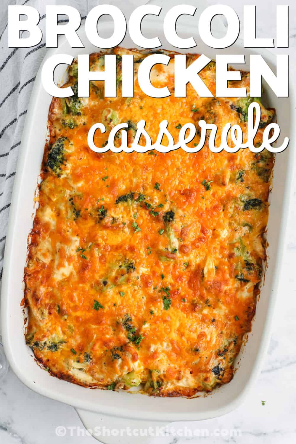 Broccoli chicken casserole is a warm, cheesy dinner made for busy evenings. Frozen broccoli saves chopping, while leftover chicken or chopped rotisserie chicken cuts preparation to about 10 minutes. A creamy mixture of cheddar, mushroom soup, sour cream, mayonnaise, and eggs bakes into a rich filling with a golden cheese topping. This easy chicken casserole also freezes well in portions. Pin it now for a comforting make-ahead meal. #theshortcutkitchen top view of Broccoli Chicken Casserole in a casserole dish with a title