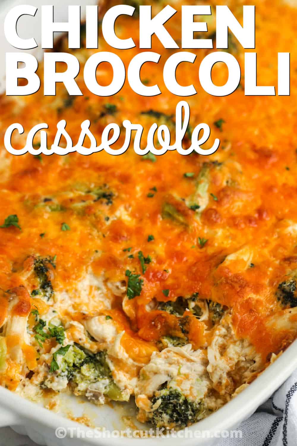 Make this cheesy broccoli chicken casserole when a cozy dinner needs to be simple. Tender frozen broccoli and cooked chicken are folded into a rich mushroom, sour cream, and cheddar mixture, then baked until hot and golden. This creamy broccoli chicken casserole takes only 10 minutes to assemble and is a practical way to use leftover chicken. Add rice or warm bread for a filling family meal. Pin this recipe for a busy weeknight. #theshortcutkitchen cheesy Broccoli Chicken Casserole in the dish with writing