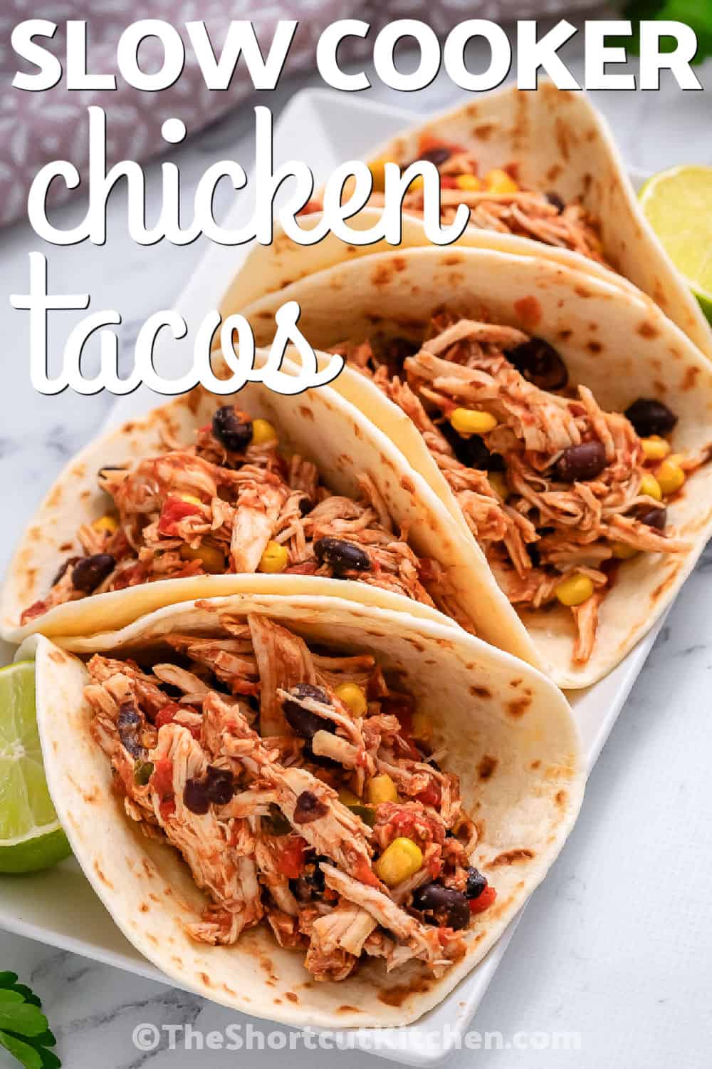 plate of flavorful Crockpot Shredded Chicken Tacos with a title
