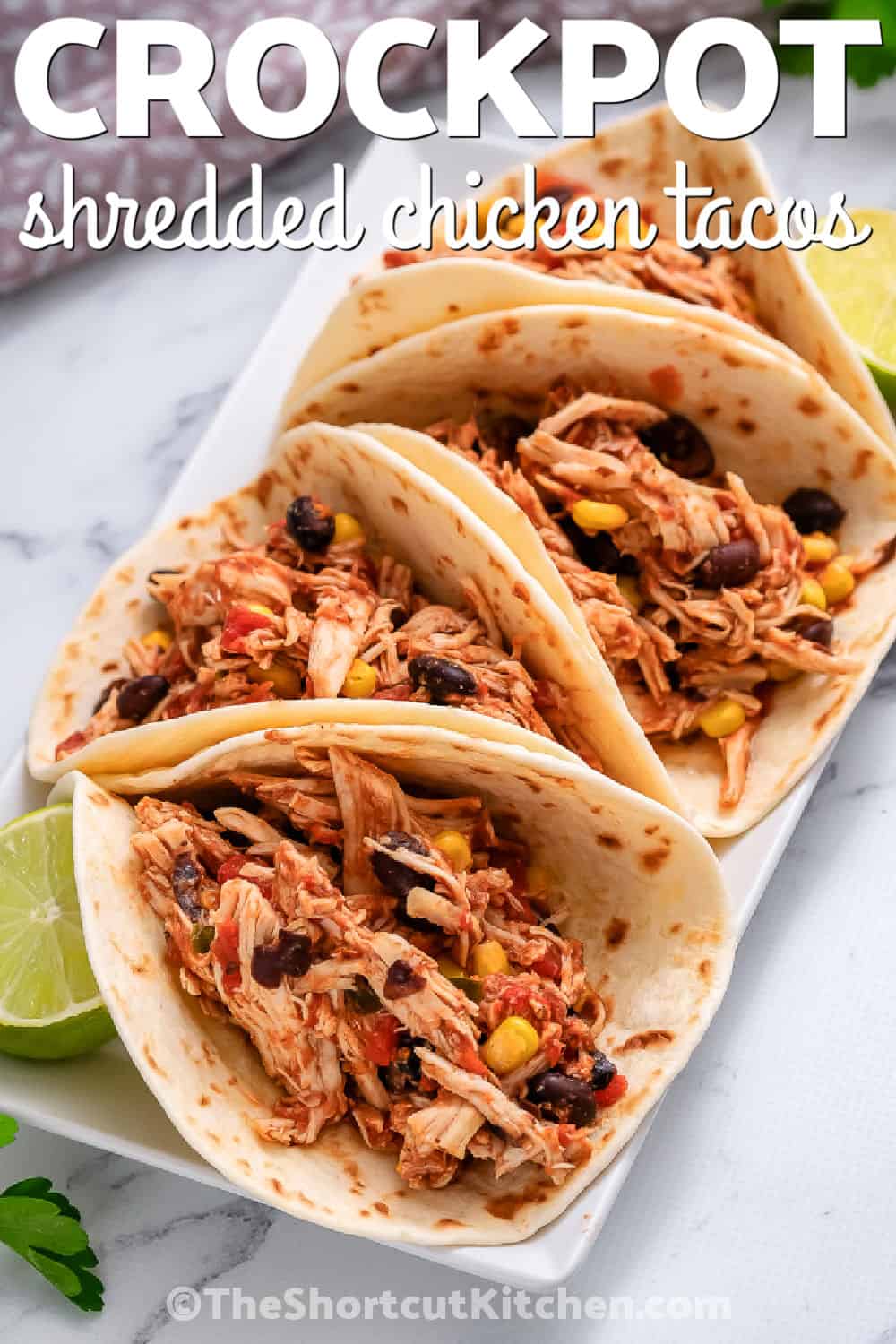 plated Crockpot Shredded Chicken Tacos with a title
