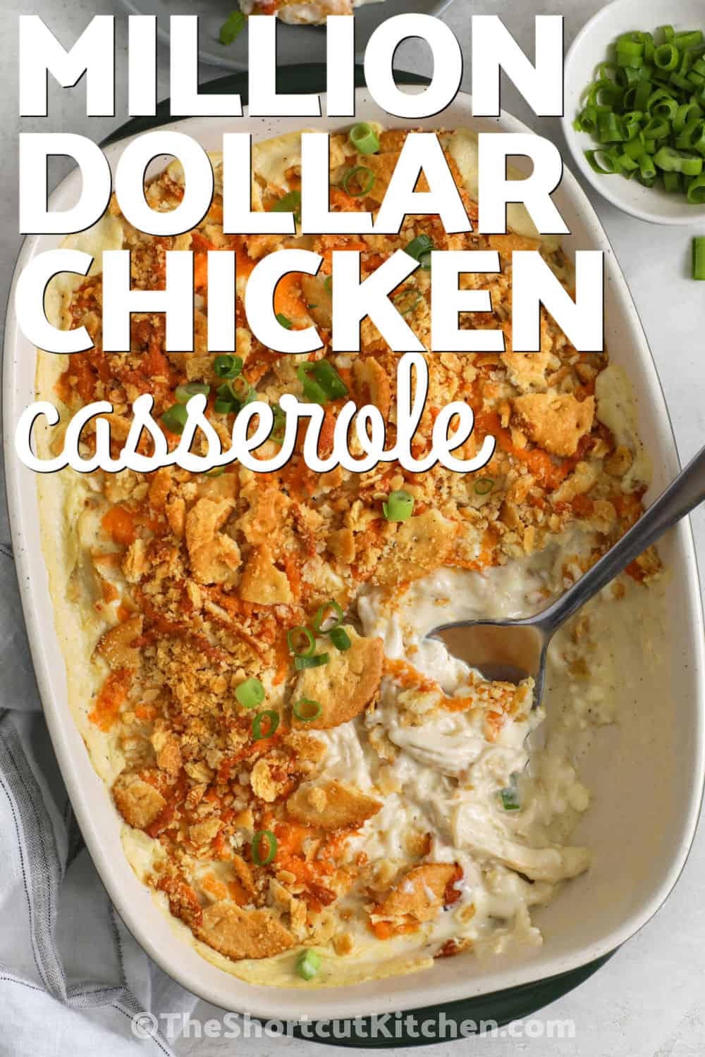 When you want comfort food, million dollar chicken casserole is a delicious dinner choice. The creamy chicken filling, sharp cheddar cheese, and buttery cracker crust create a satisfying dish that everyone loves. This easy baked casserole is perfect for weeknight dinners, gatherings, or whenever you want a hearty homemade meal. Make this recipe today and enjoy a new family favorite. #theshortcutkitchen top view of Million Dollar Chicken Casserole in the dish with a title