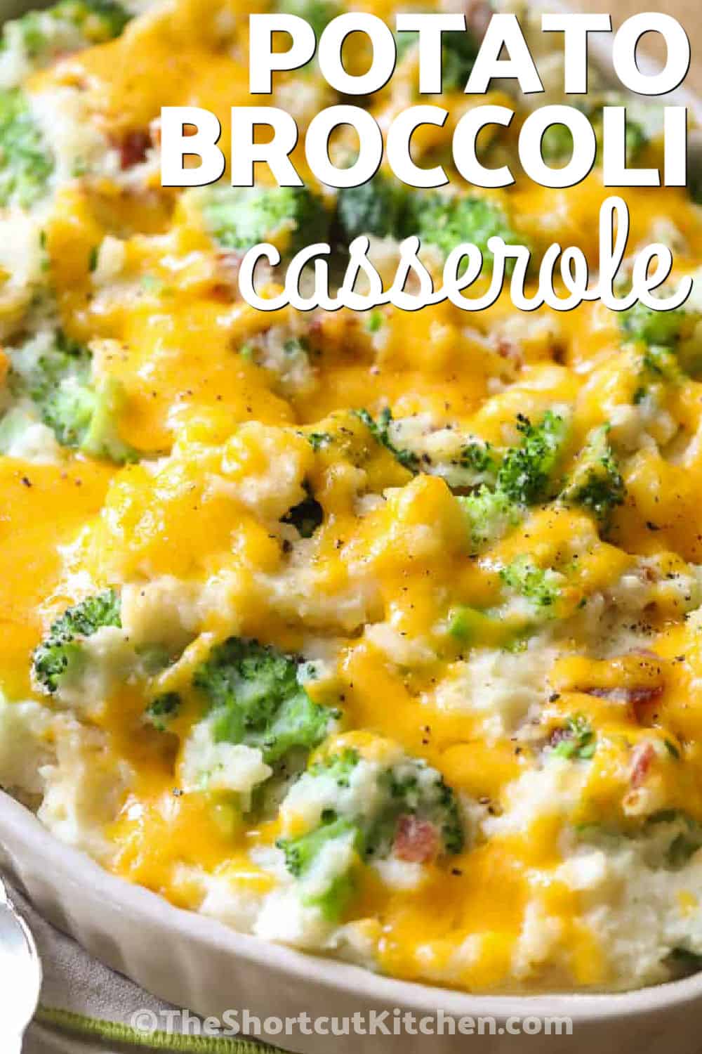 Creamy potatoes, green broccoli, smoky bacon, and melted cheese make this broccoli potato casserole hard to resist. The potatoes and broccoli are cooked first, folded with a rich cream cheese mixture, and baked under sharp cheddar. Serve this easy broccoli cheddar potato casserole with chicken, pork, beef, or a holiday roast. Add it to your casserole board and make it for dinner soon. #theshortcutkitchen cheesy Broccoli Potato Casserole with a title