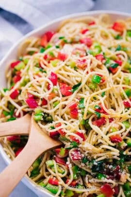 Spaghetti Salad in a bowl with wooden spoons