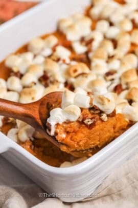 taking a spoonful of Canned Sweet Potato Casserole out of the dish.