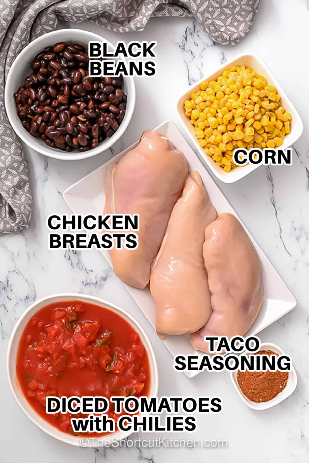 ingredients to make Crockpot Shredded Chicken Tacos labeled: black beans, corn, chicken breasts, taco seasoning, diced tomatoes with chilies