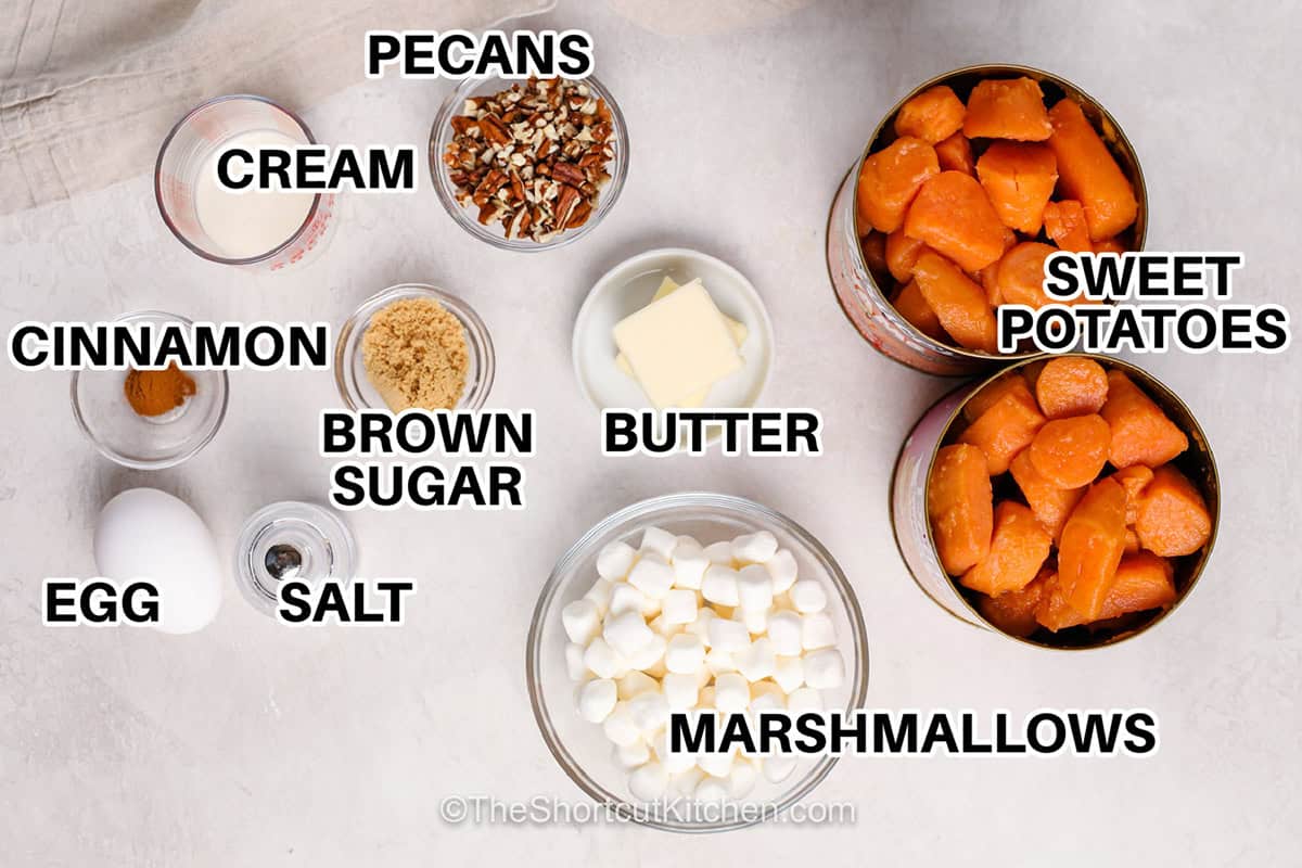 Canned sweet potato casserole makes holiday cooking easier with canned sweet potatoes, brown sugar, cinnamon, and cream mashed until smooth. A buttery topping of mini marshmallows and chopped pecans turns golden and gooey in the oven. This easy sweet potato casserole with canned yams needs only 10 minutes of prep and makes a cozy Thanksgiving or Christmas side dish for eight. Save this easy holiday recipe for your menu. #theshortcutkitchen pecans ,sweet potatoes , marshmallows , butter , pecans , brown sugar , cream, cinnamon , egg and salt with labels to make Canned Sweet Potato Casserole.
