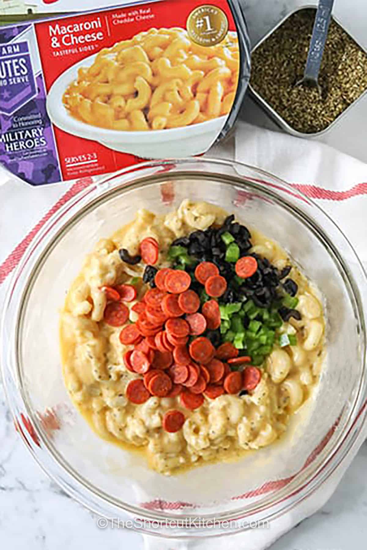 adding ingredients together in bowl to make Mac and Cheese Pizza Bites