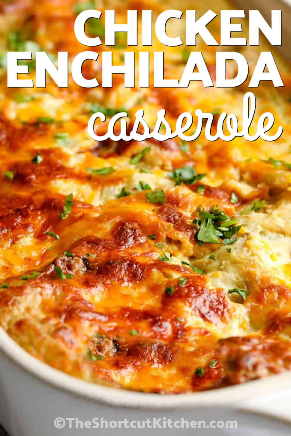 This green chicken enchilada casserole is one of the easiest ways to enjoy enchilada flavors without rolling tortillas. Made with cooked chicken, green enchilada sauce, sour cream, Monterey Jack cheese, and corn tortillas, it's an easy casserole everyone will love. Pin it now. #theshortcutkitchen close up of Chicken Enchilada Casserole with a title