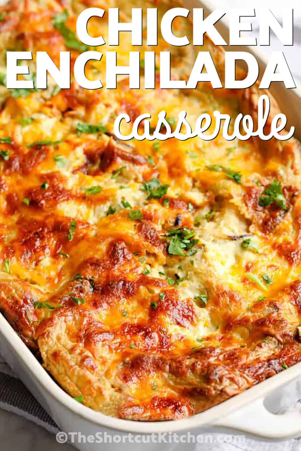 Chicken enchilada casserole is layered with tender chicken, tortillas, green enchilada sauce, black beans, and gooey melted cheese. This shortcut recipe comes together quickly using cooked or rotisserie chicken and bakes into a hearty family favorite. Pin this easy dinner idea for later. #theshortcutkitchen cheesy Chicken Enchilada Casserole with a title